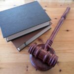 A mallet beside two law books