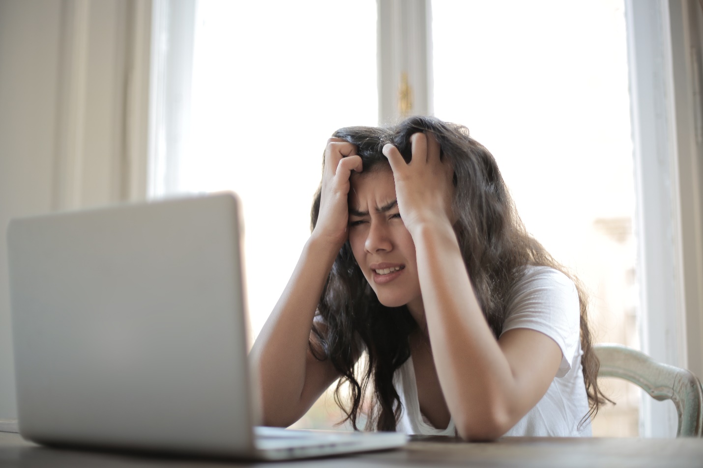 Frustrated Woman in front of the laptop