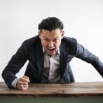 Man in suit screaming