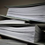 Stacked folders of employee policies